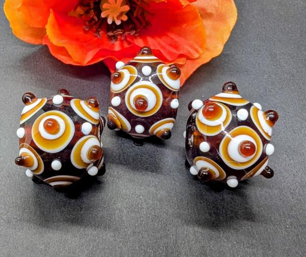eye bead amber colored white